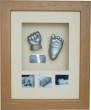 Baby hand and foot cast framed with photos